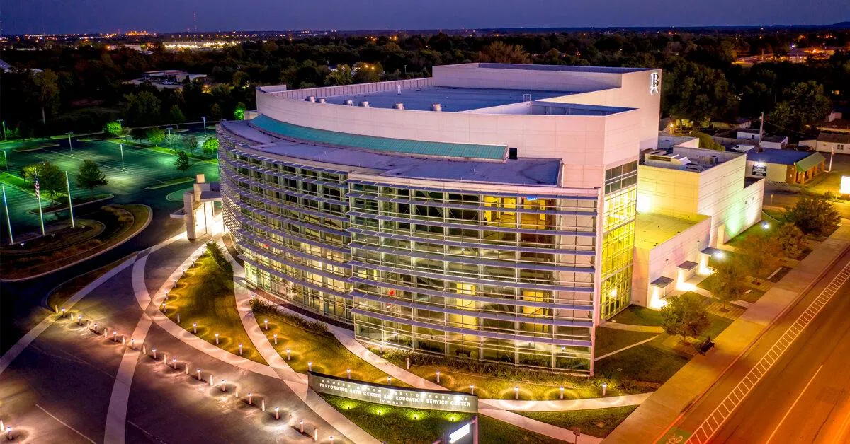 Aerial night view of a modern office building and city center in Broken Arrow.