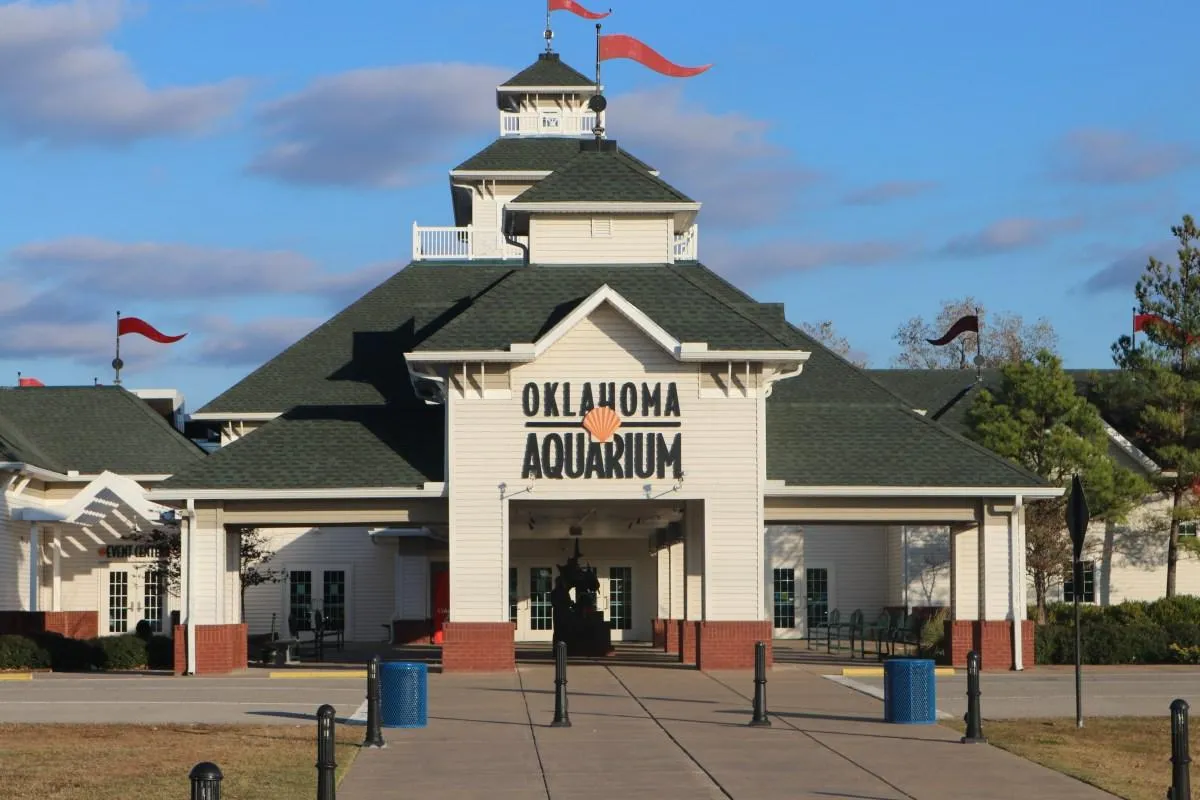 Exterior view of the Oklahoma Aquarium in Jenks, with pathway and landscaping.