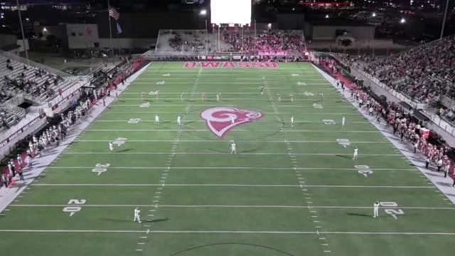 Owasso High School football stadium filled with fans during a Friday night game
