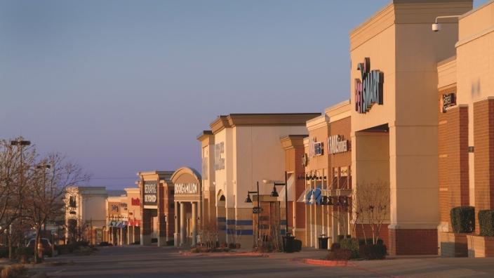 Exterior view of the Oklahoma Aquarium in Jenks, with pathway and landscaping.