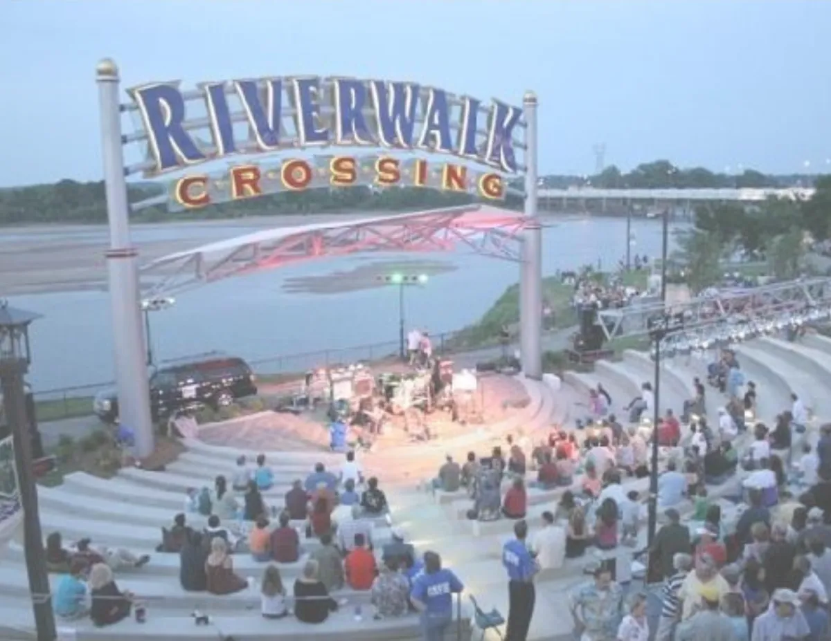 Outdoor concert at the Jenks Riverwalk Crossing amphitheater overlooking the river.