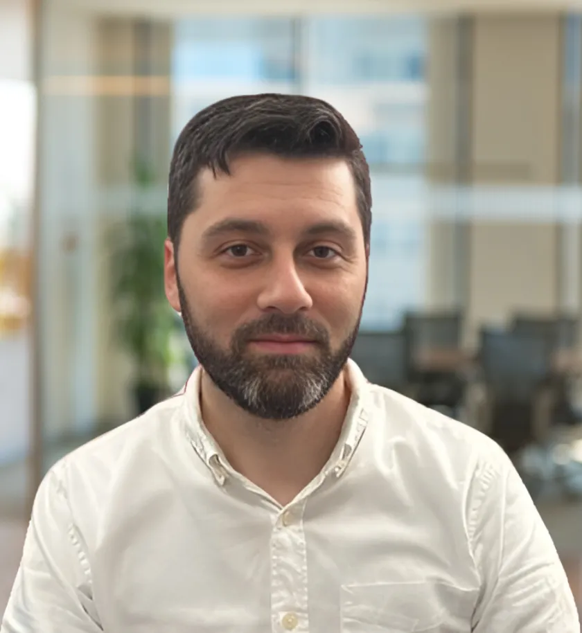 A marketing consultant meeting with a small business owner in a cozy office, both reviewing a marketing plan on a laptop, with coffee cups and notepads on the table, showing a supportive, collaborative environment.