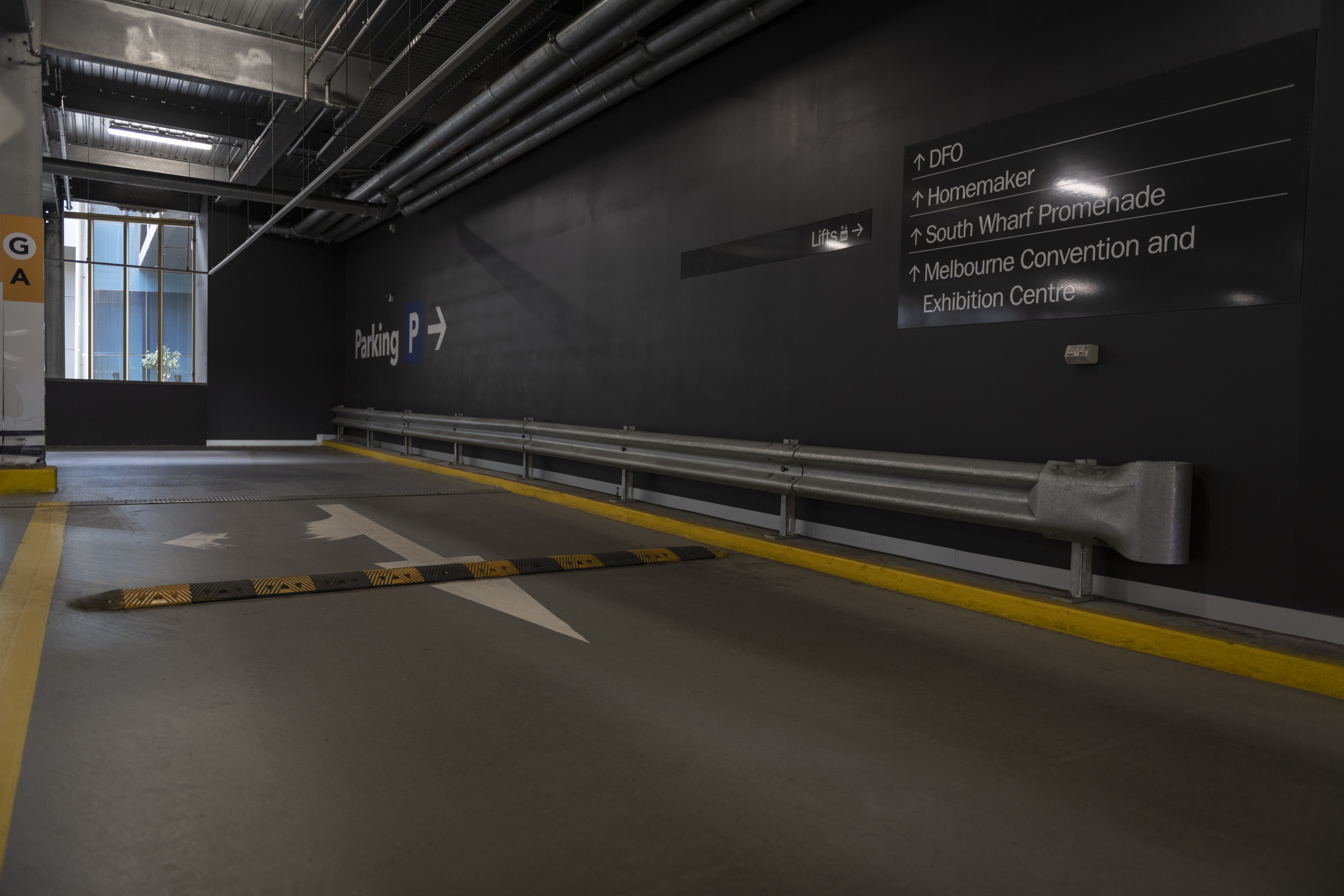 a man wearing a hard hat standing in the rain