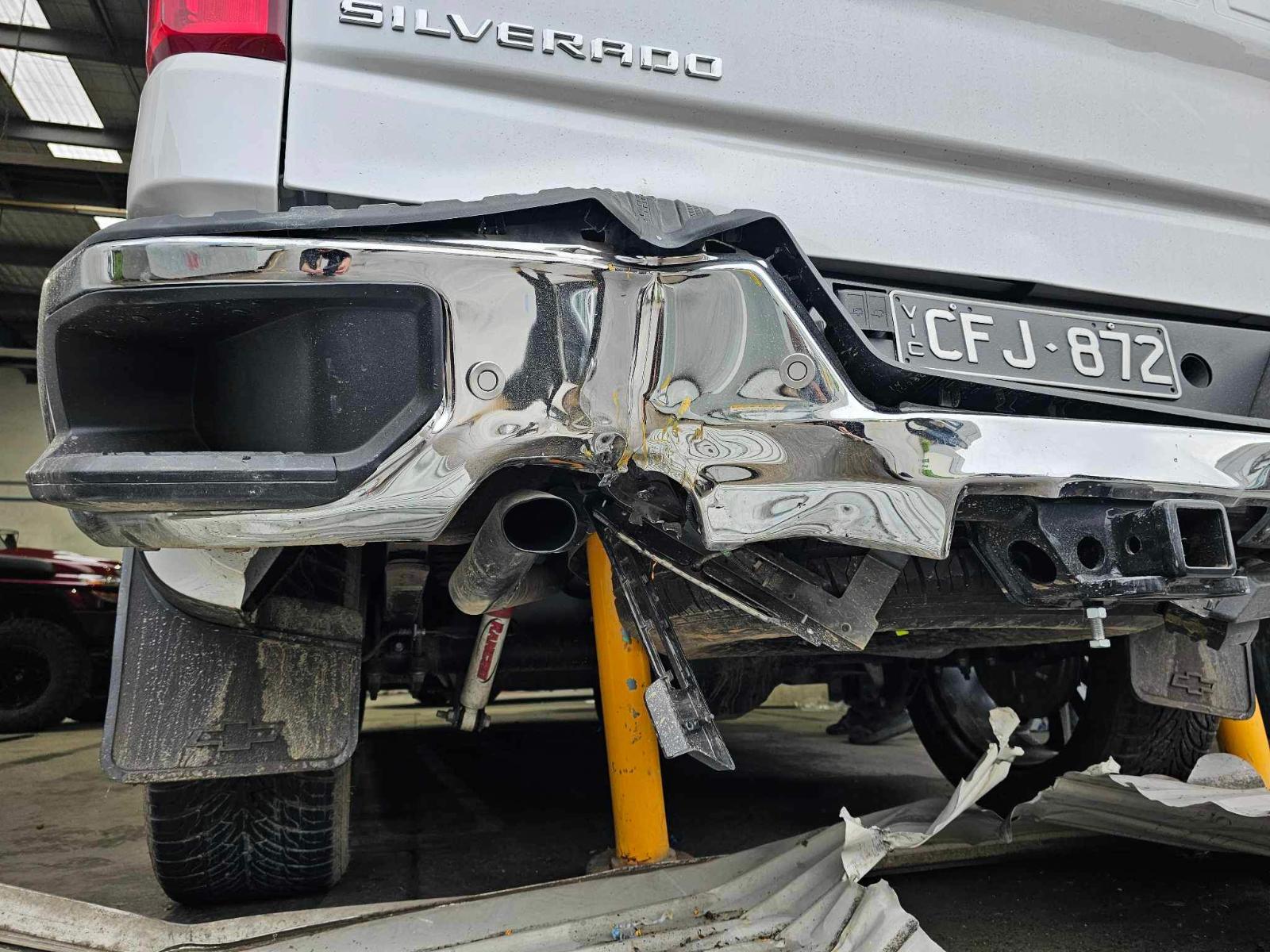 A red motorcycle parked in front of a gas station