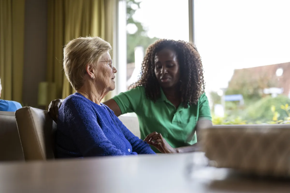 elderly woman with caregiver at home