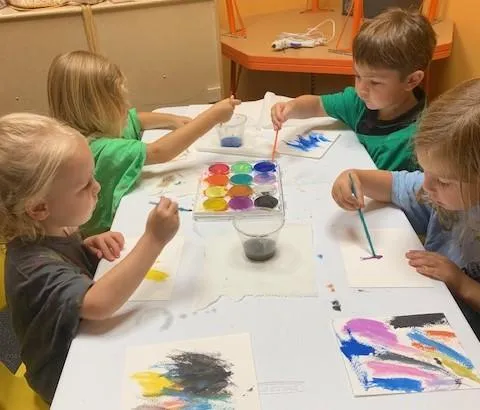 Girl follows directions during arts and crafts time.