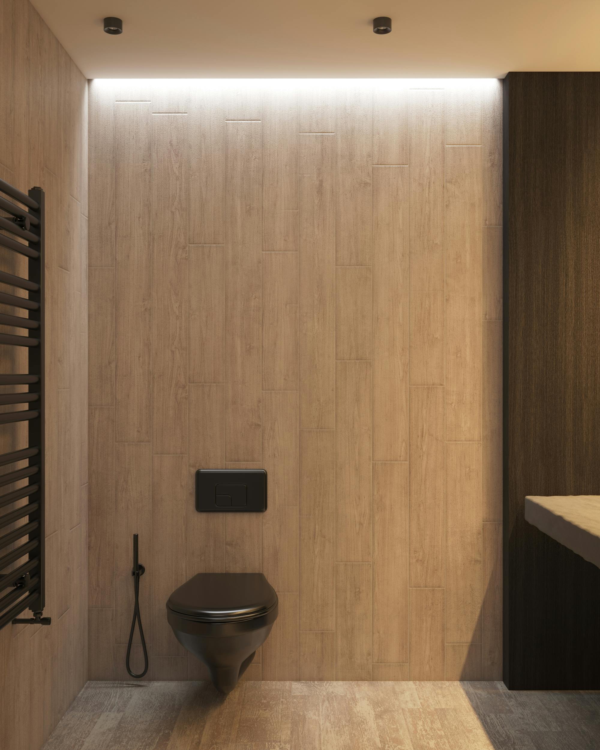 wooden walls and floor tiles with black toilet connected to wall