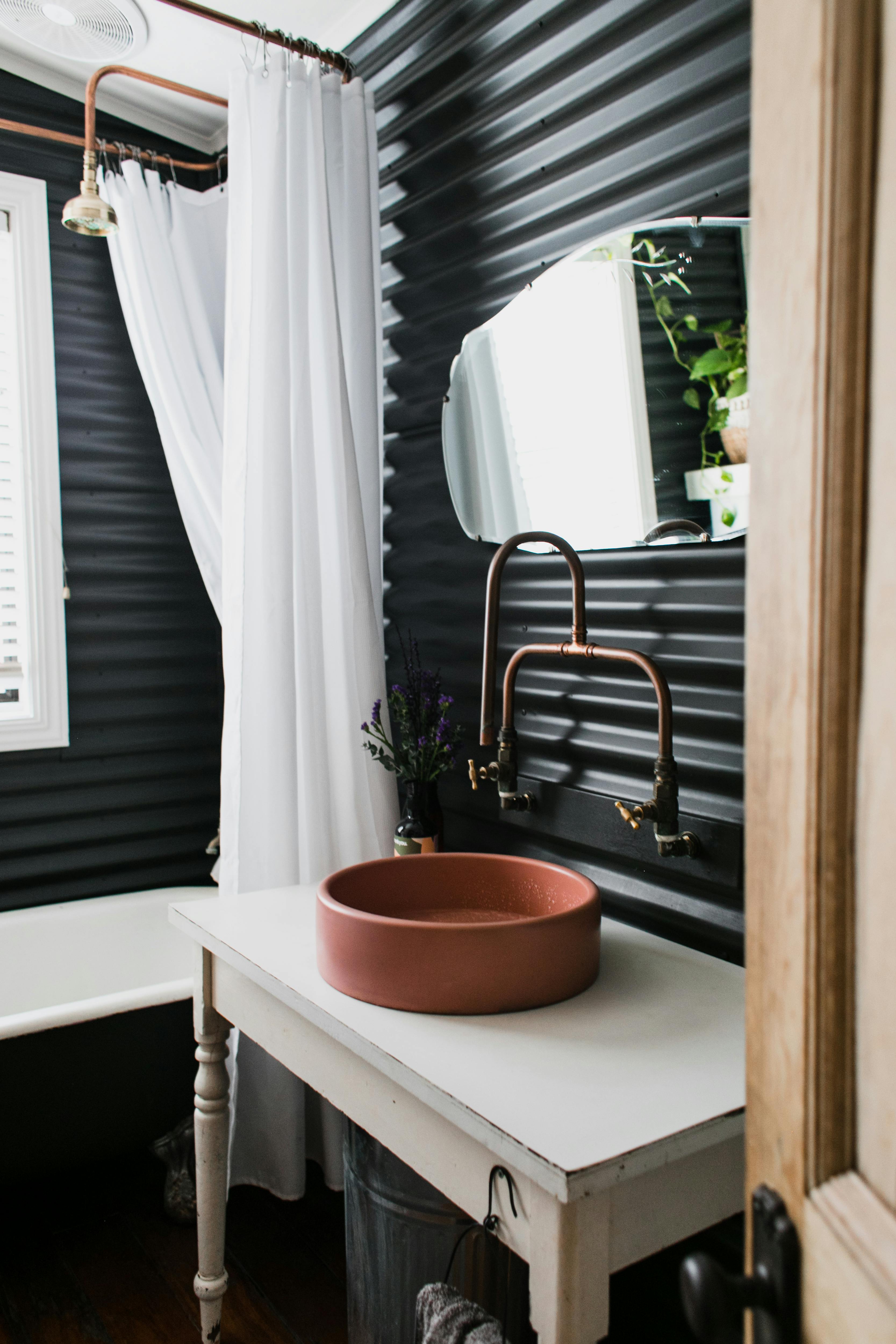 black metal enclosre with a copper basin with a clay basin