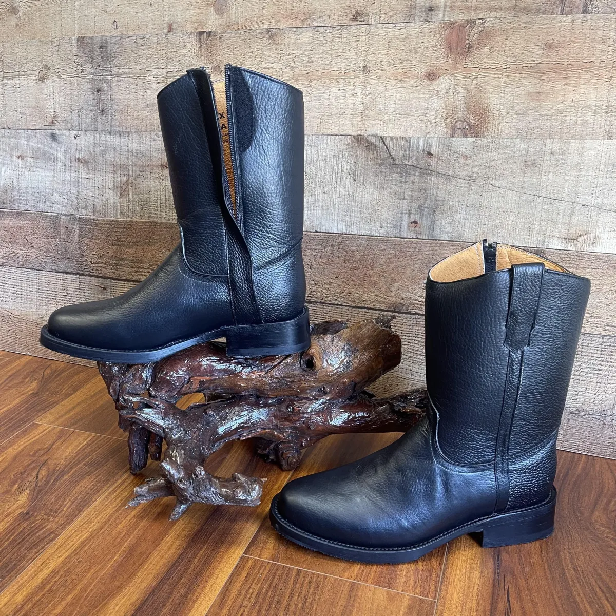 brown suede boots beside silver iphone 6 on brown wooden table