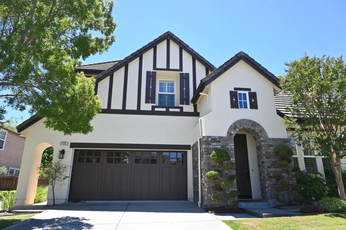 Exterior stucco house paining with beige color on the walls, and brown color on all trim in Novato, CA.