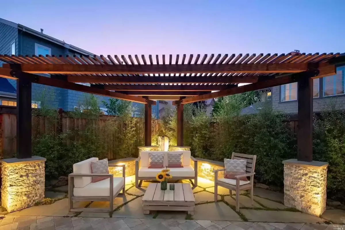 Custom pergola construction on Oak Grove Drive in Novato, California, featuring natural stone-clad concrete columns, cedar timber framing, and a flagstone patio.