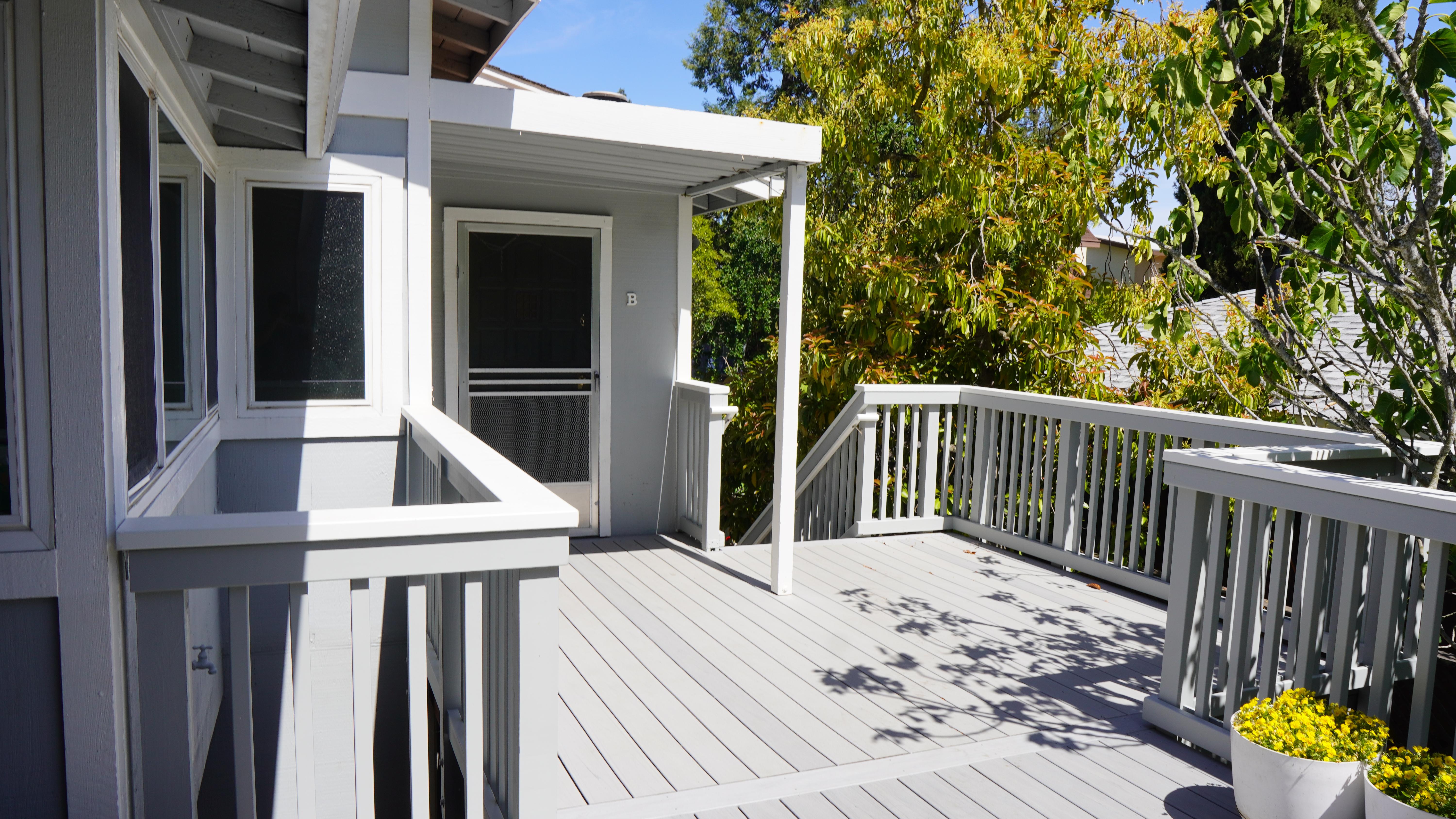 Grey Trex Decking with wooden railings pained grey in Kentfield, CA.