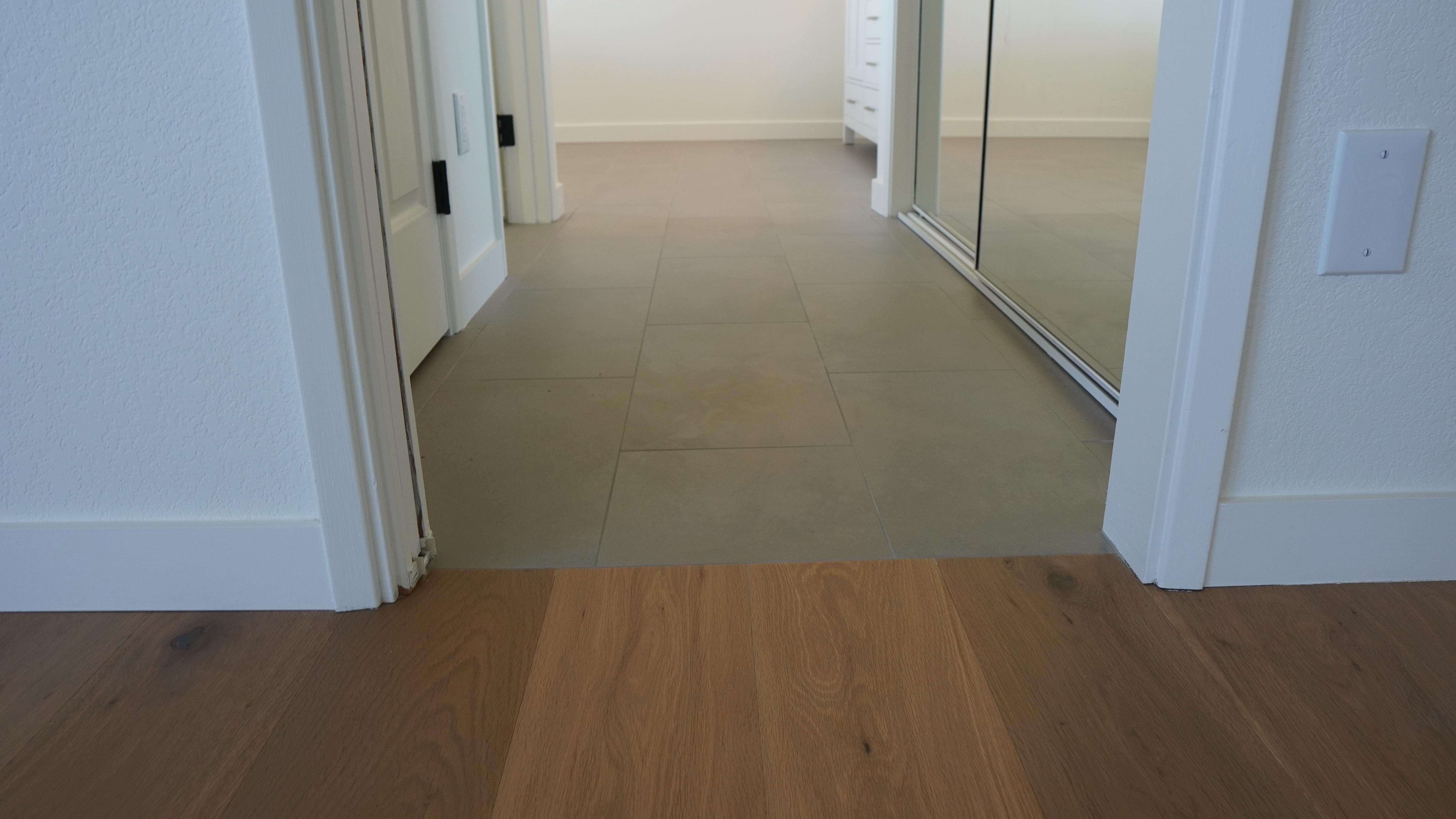 Even tile and hardwood floor elevation in the master bathroom in Novato, CA