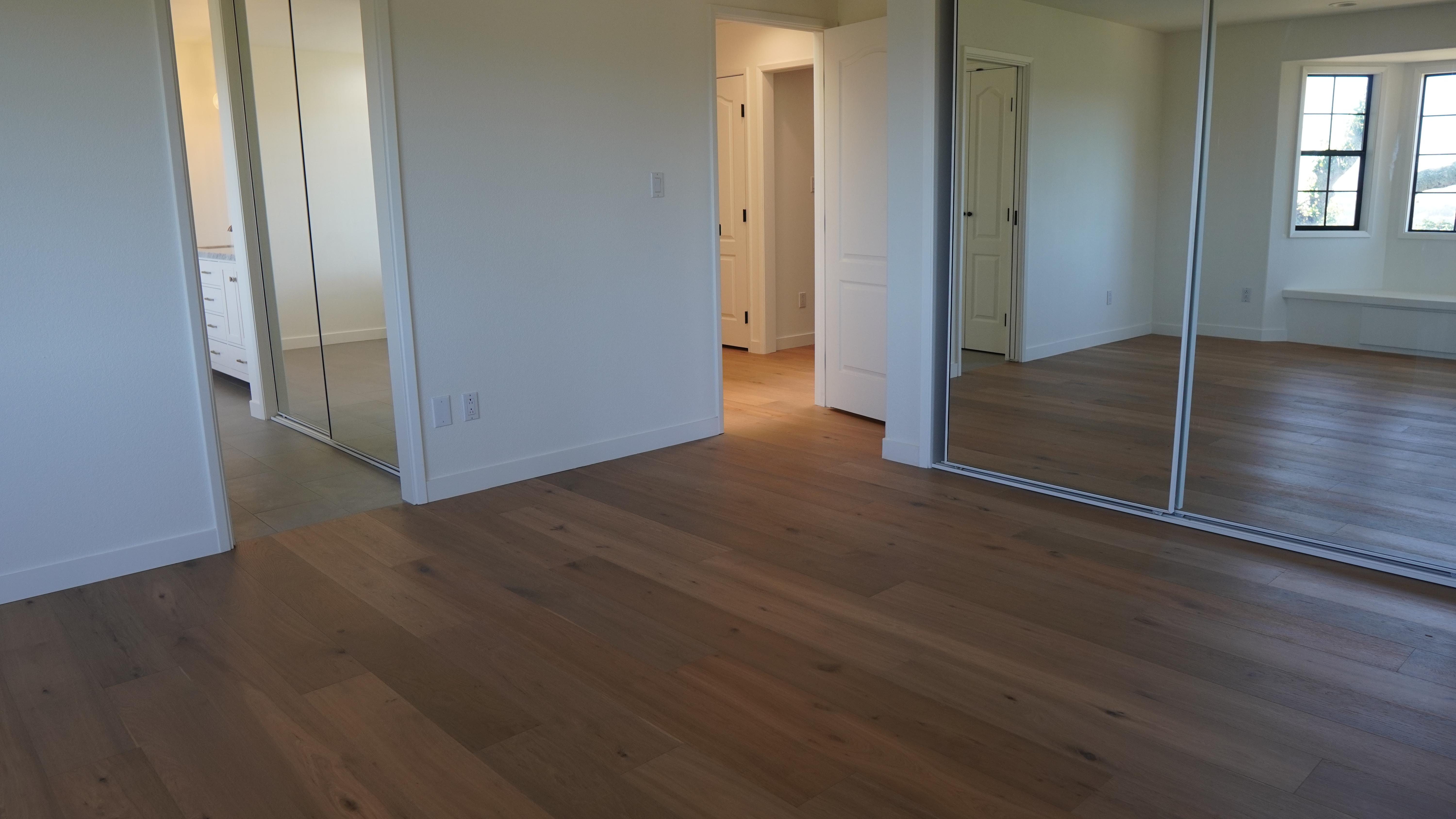 New whit oak flooring installation in mater bathroom with toll closet doors in Novato, CA