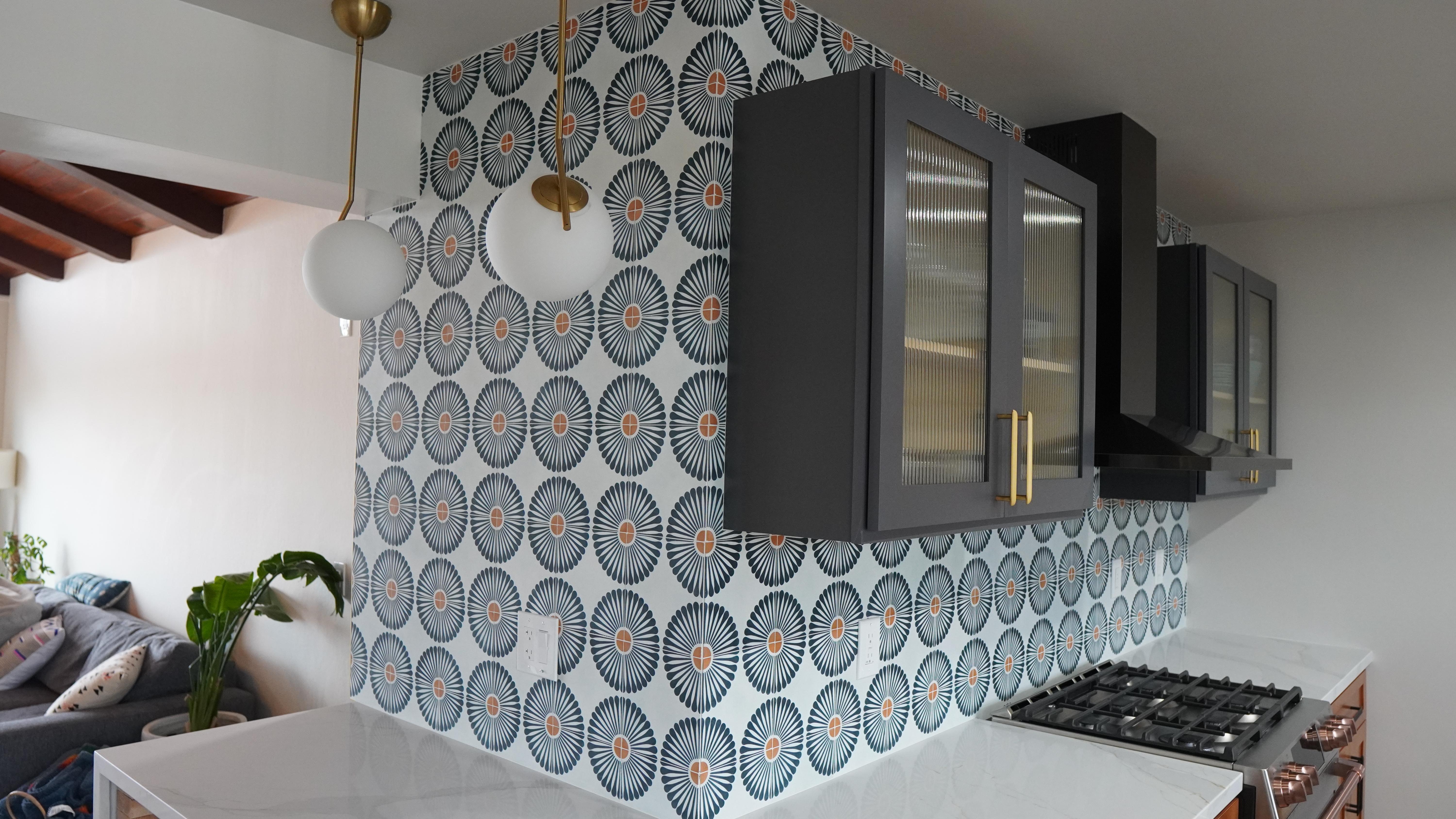 Kitchen Remodel featuring white quartz countertops, flower like backsplash, blue wall cabinets with glass doors, golden handles in Corte Madera Ca.