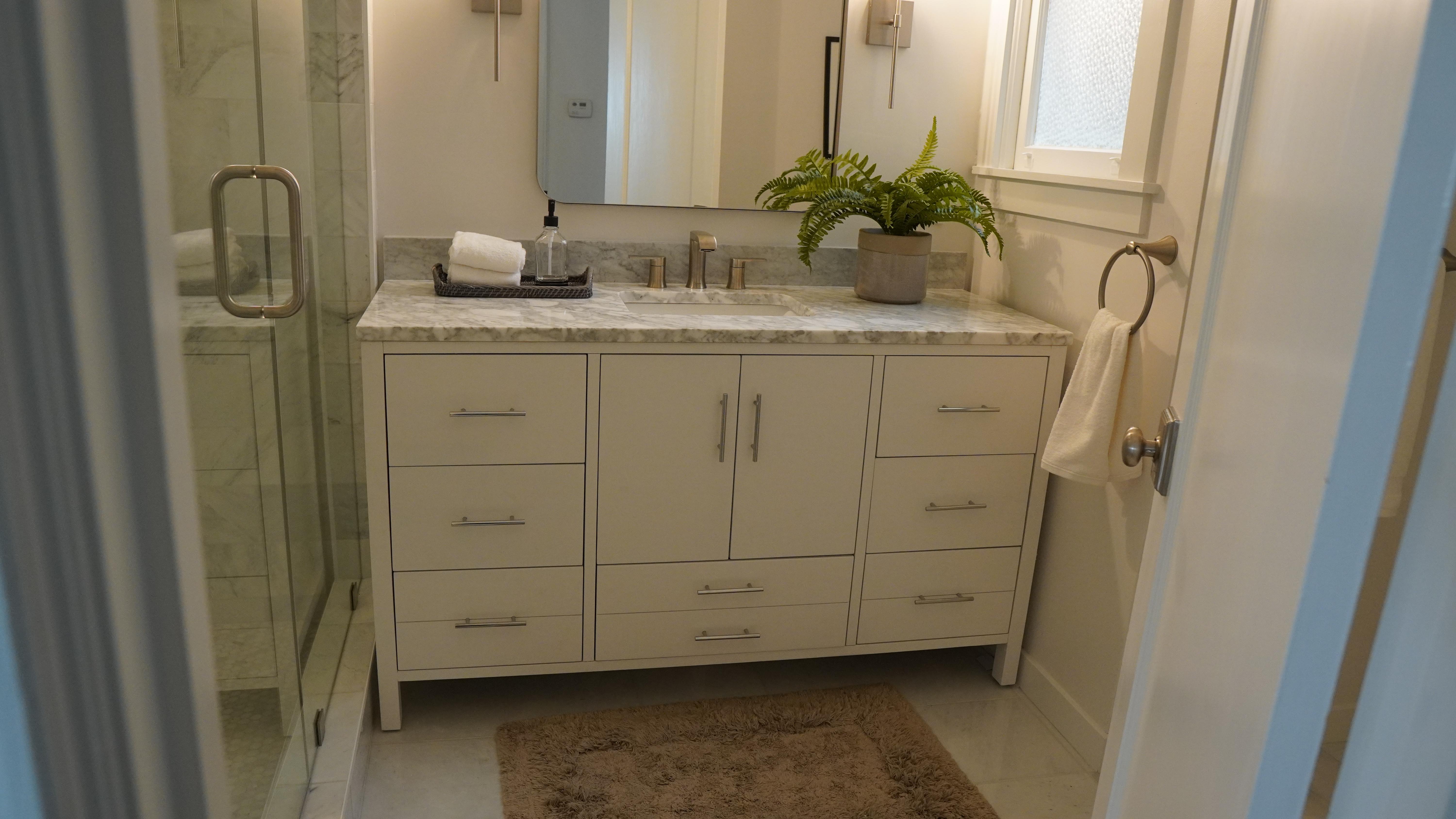 Yes. I’d make the alt text descriptive but natural, with San Francisco bathroom rem  San Francisco bathroom remodel featuring a premium white vanity with Carrara marble countertop, square LED mirror, wall sconces, and glass-enclosed shower.  