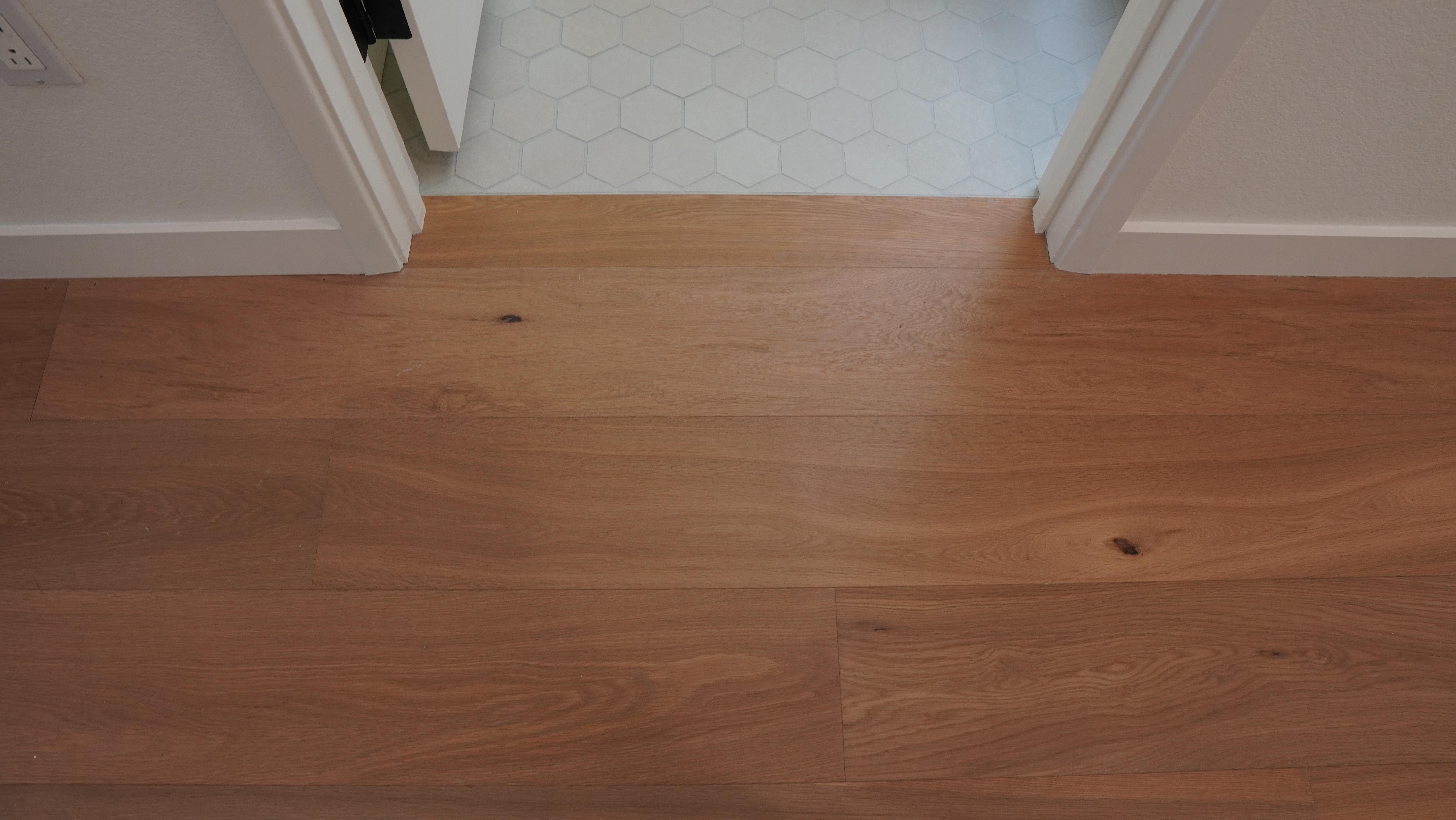 Even floor elevation between hallway tile floor and hallway hardwood floor in Novato, CA.
