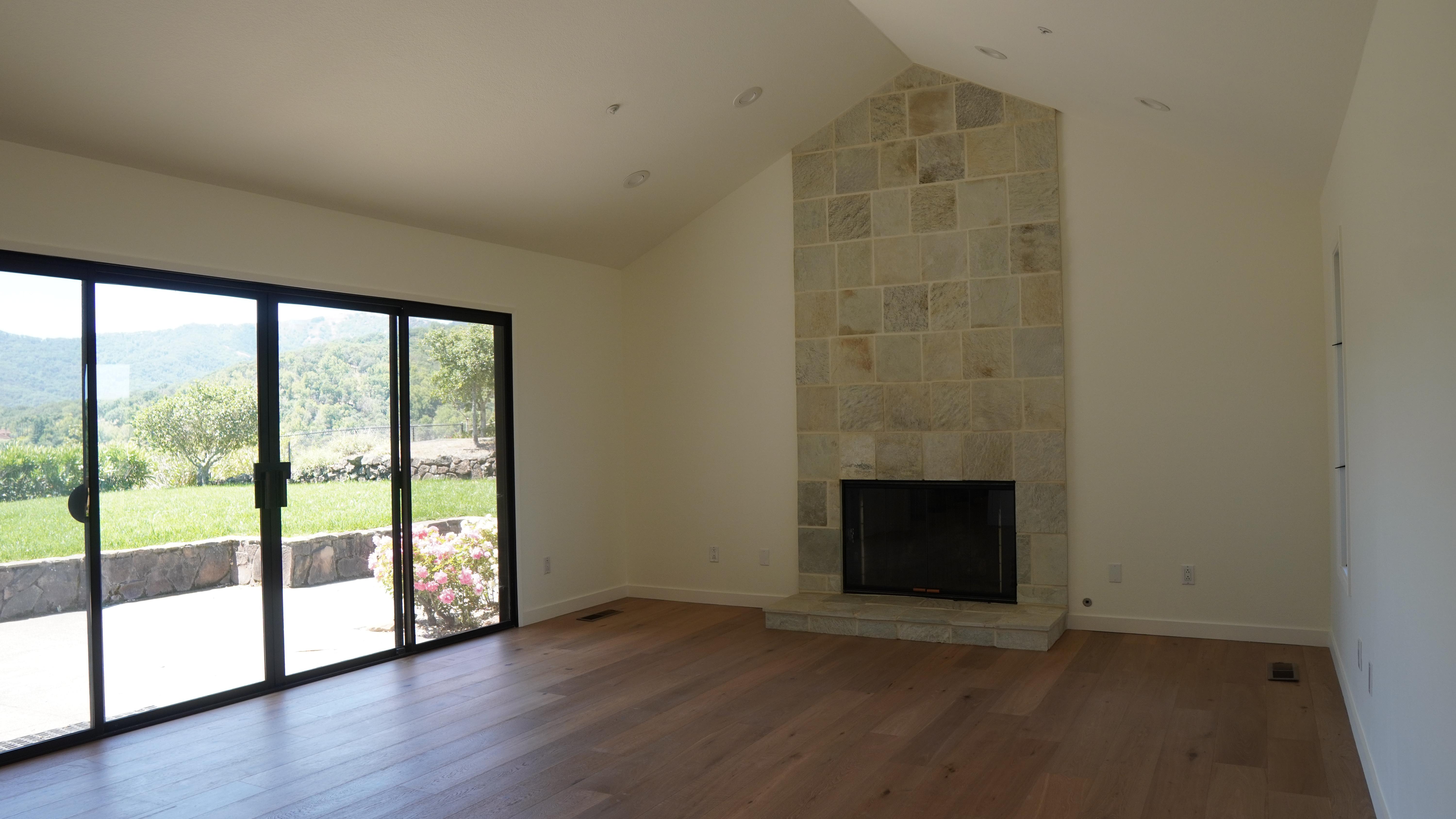 Living room chimney decorated with natural stone in Novato, CA.