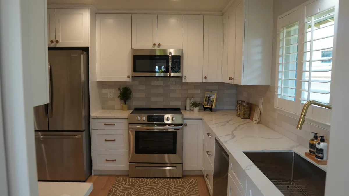 Kitchen remodel featuring white shaker cabinets, cream quartz counter-tops, golden kitchen faucet in san Carlos CA