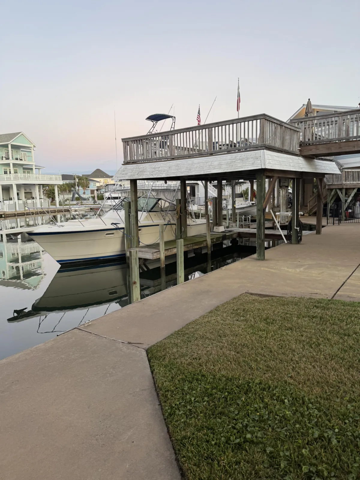 Walkable neighborhood street in Galveston County with mature trees and local homes