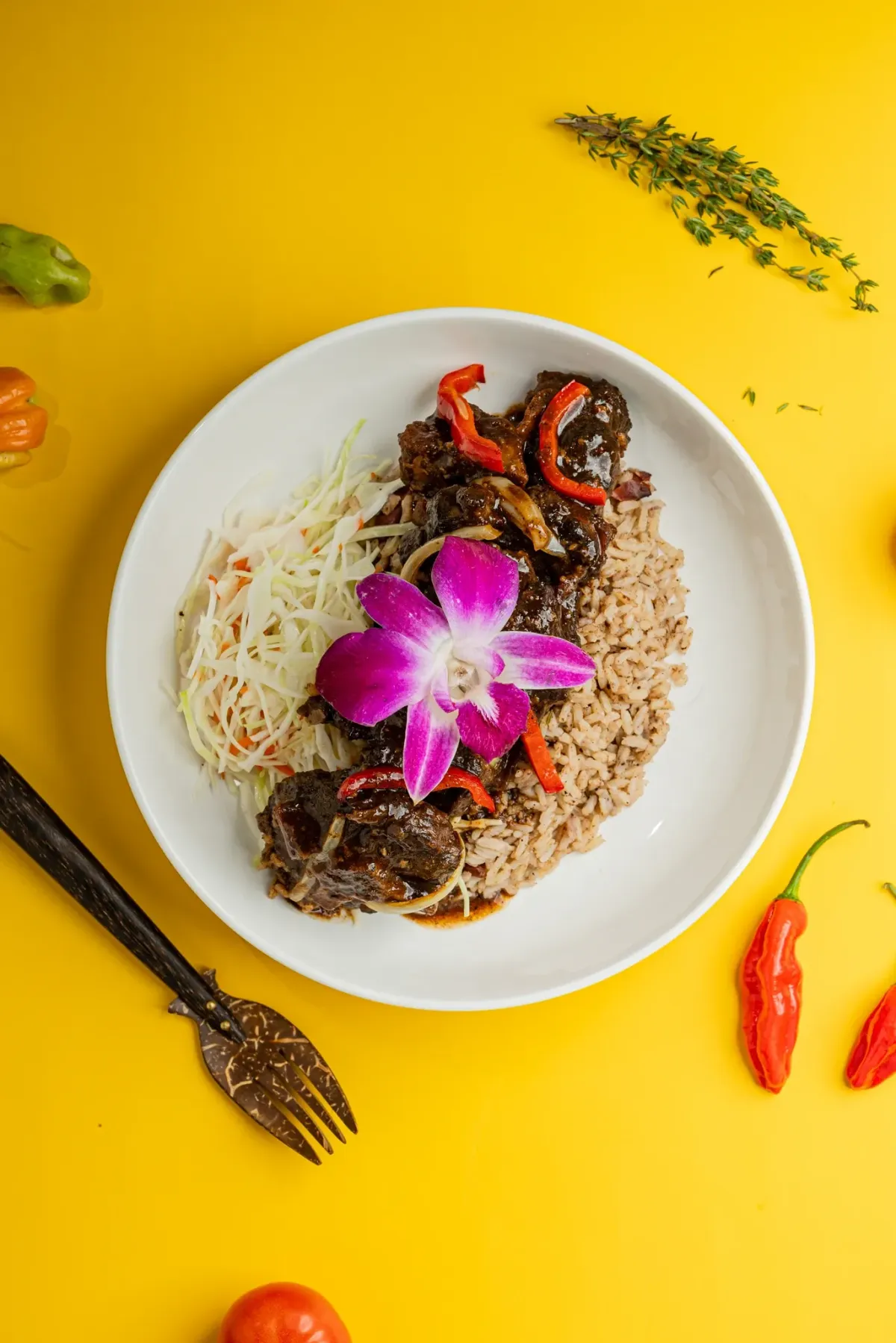 Chef arranging plated hors d'oeuvres on a wooden platter in a bright prep kitchen