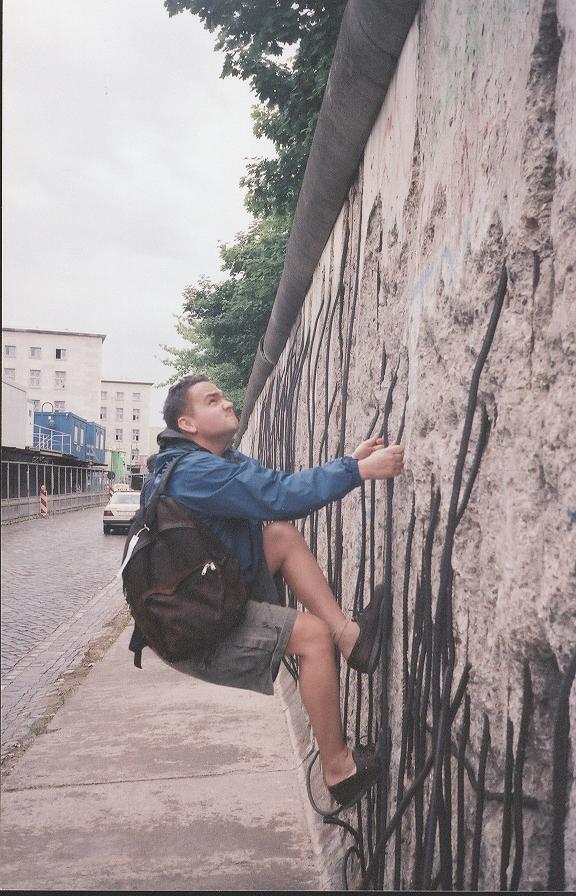 Photo of Eric Woodard climbing the Berlin Wall