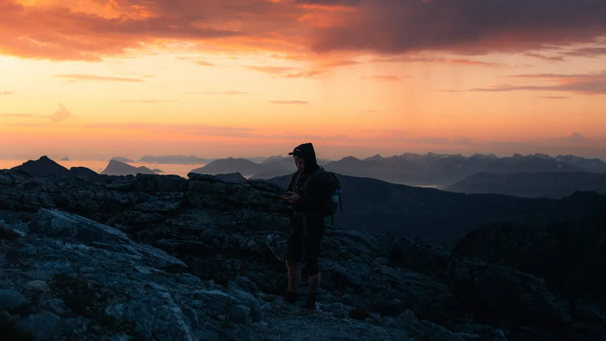 Johan Vesters hiking at sunset in Norway, for a post on how to deal with bloating, gas and indigestion with Allie Saez