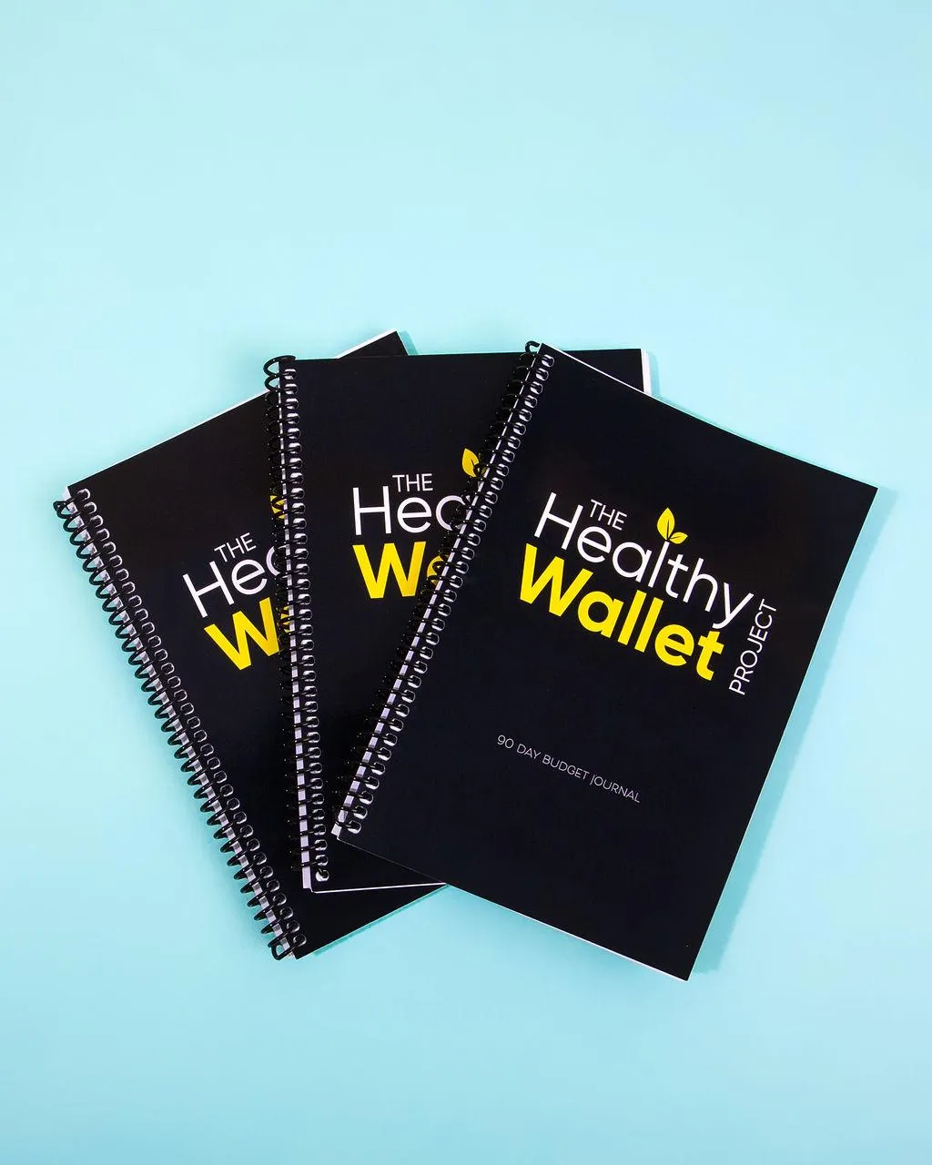 three journals lying down together.