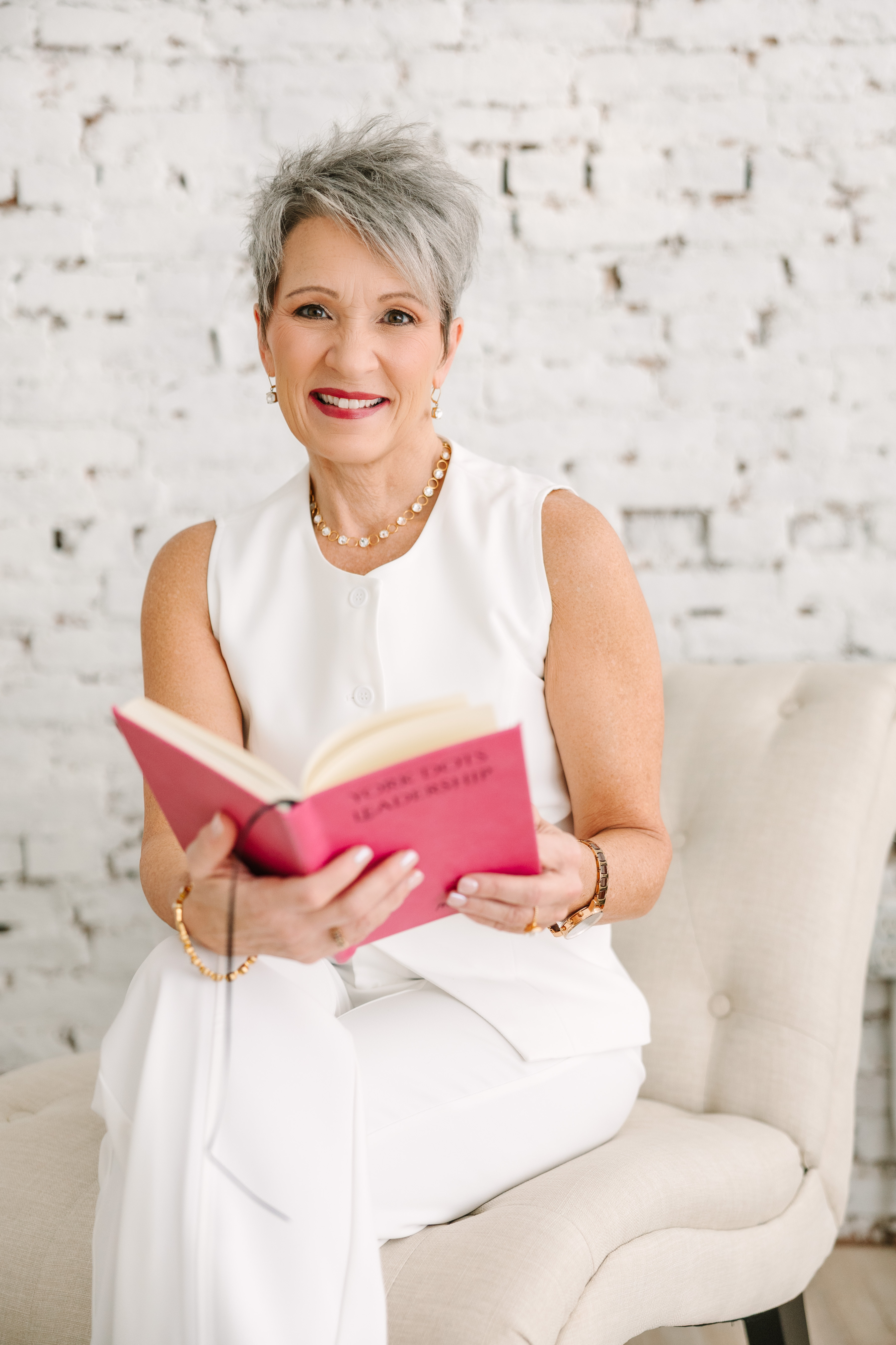 Confident woman smiling while hosting a virtual coaching session