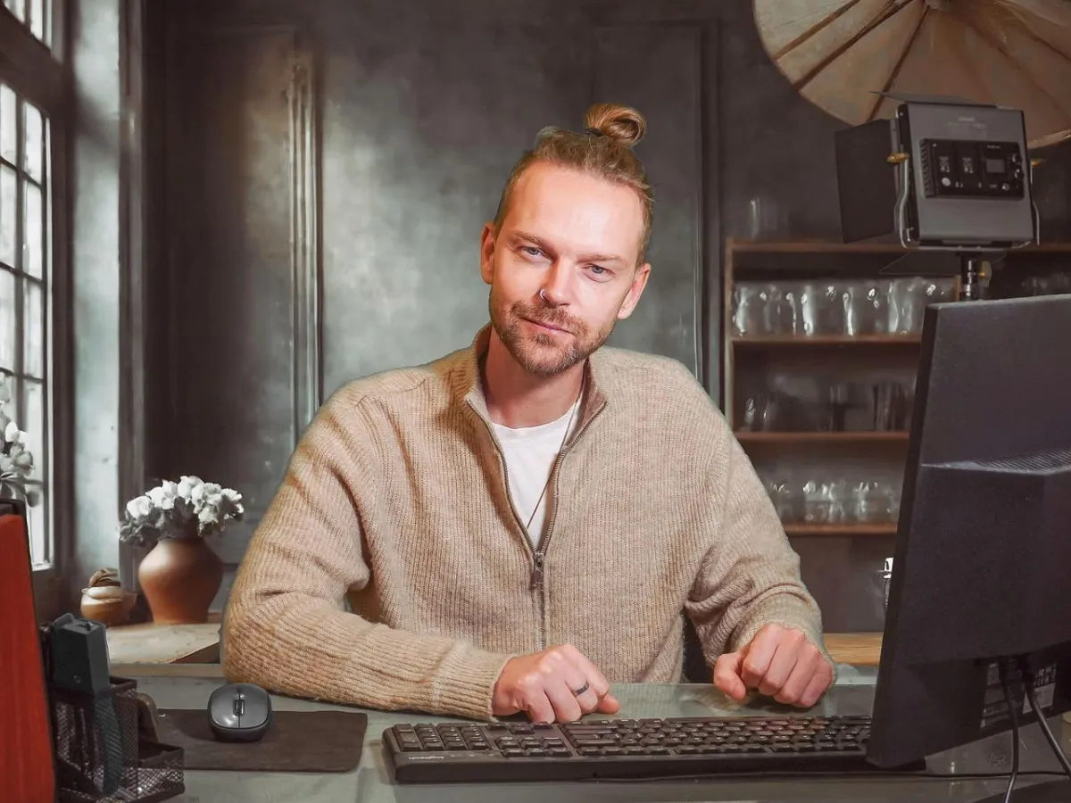 Male business owner sitting at a desk working on a computer
