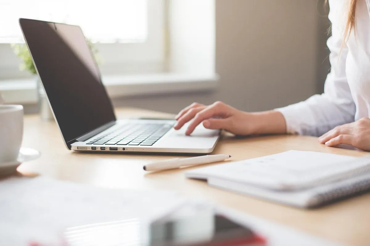 Business person typing on her macbook