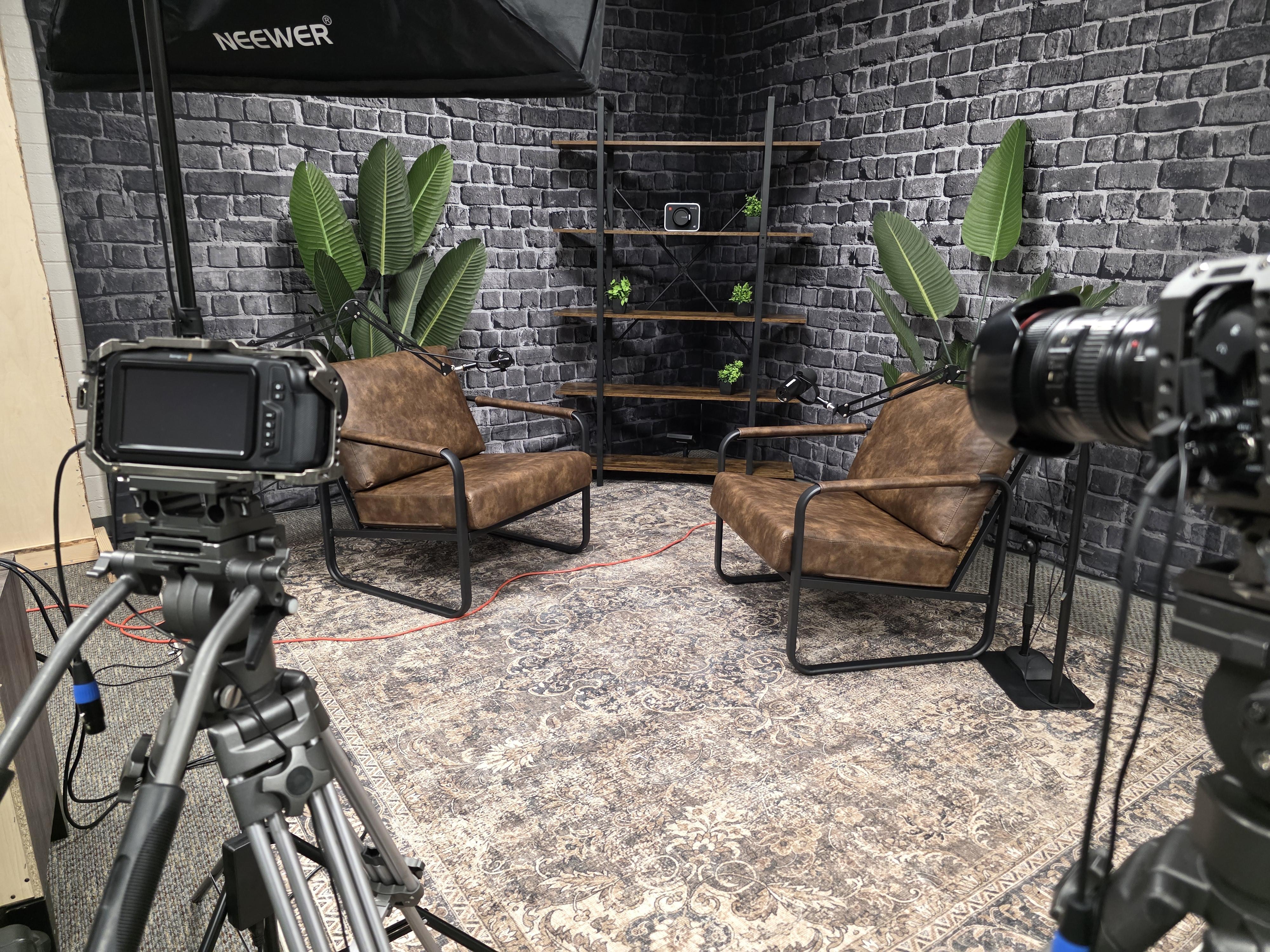 Behind the scenes in the A Squared studio: two cameras on tripods, a softbox light and cabling set up for a shoot