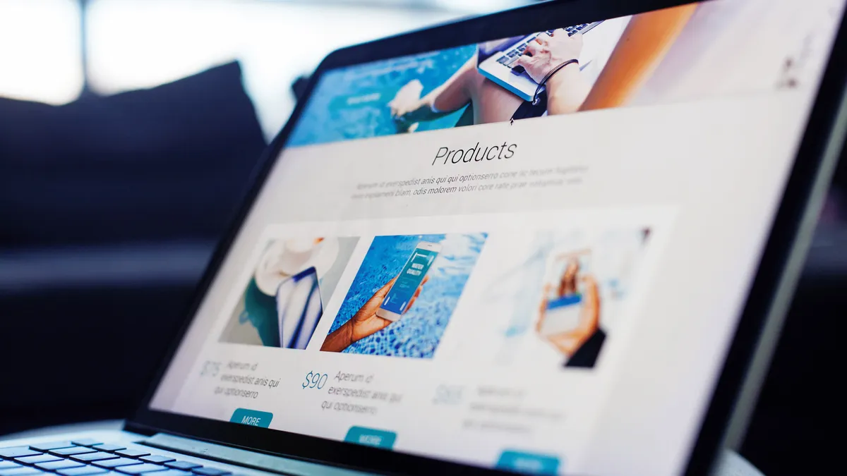 Laptop displaying a website template with product images and a grid-based page layout.