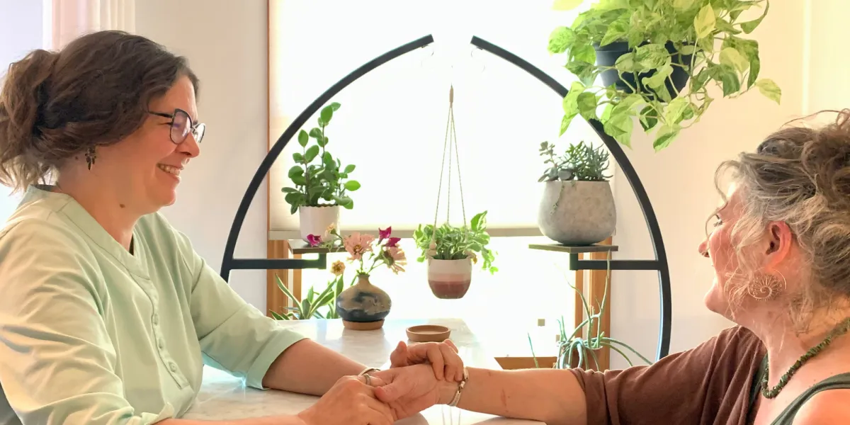 a woman in a black sports bra top sitting in a yoga pose