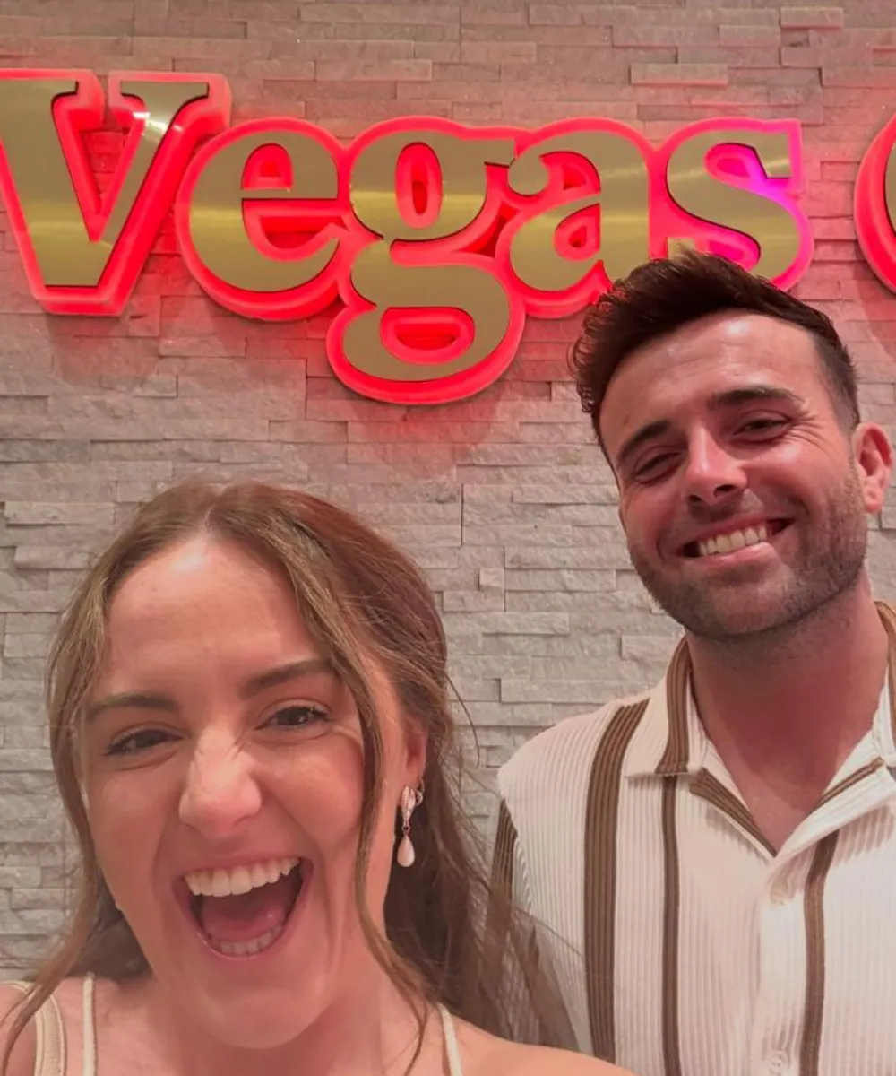 Luke & Sophie in front of a Vegas sign
