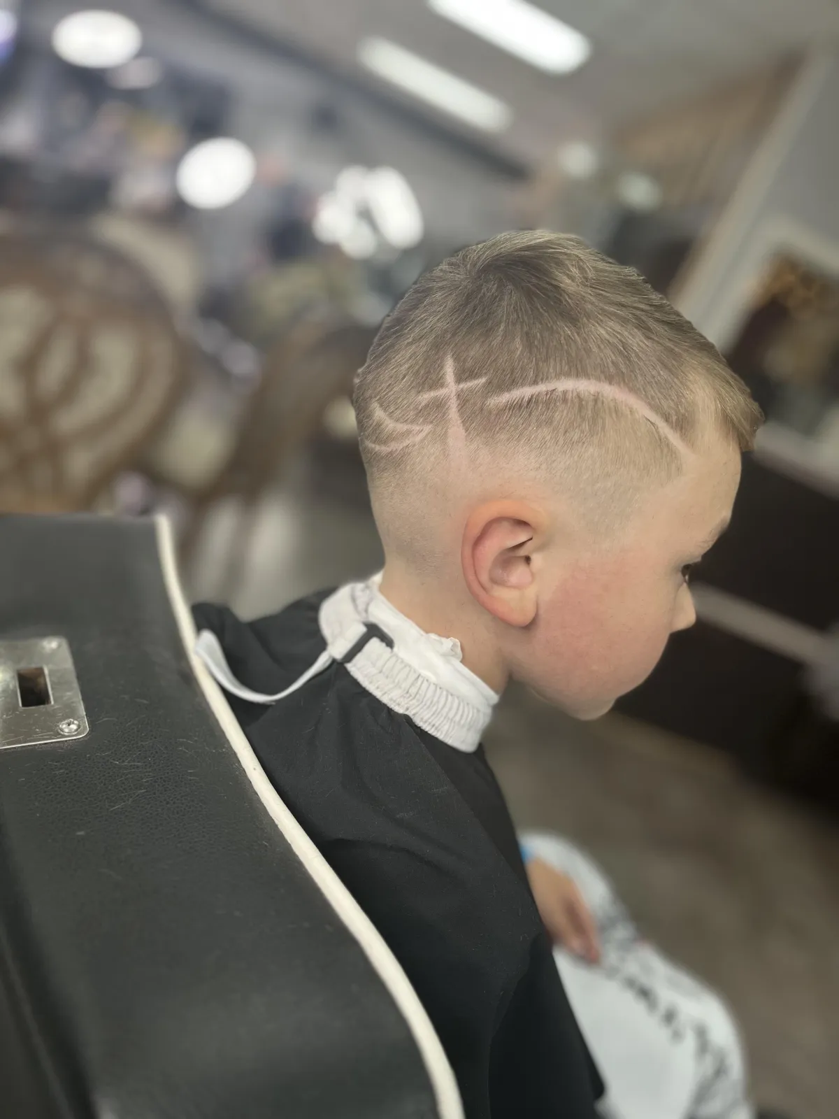 a man getting his hair cut by a barber