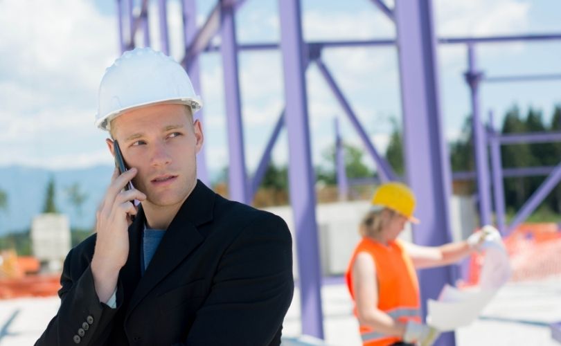 tradesman talking to his crew