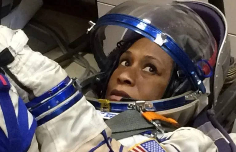 Jeanette Epps NASA astronaut headshot, Dr. Jeanette Epps keynote speaker, Astronaut Jeanette Epps in orange launch suit, Jeanette Epps conducting experiments on space station, Dr. Epps speaking engagement, Jeanette Epps ISS Expedition 71, Astronaut Jeanette Epps speaking to students