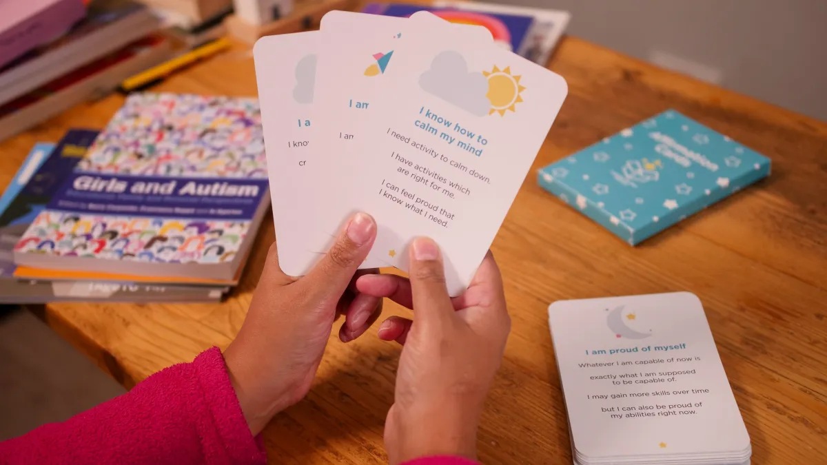 Neuro affirmation cards held in child's hands