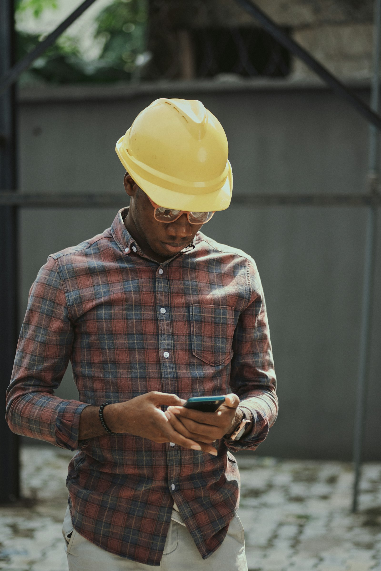 Contractor in a hard hat taking a phone call on a jobsite