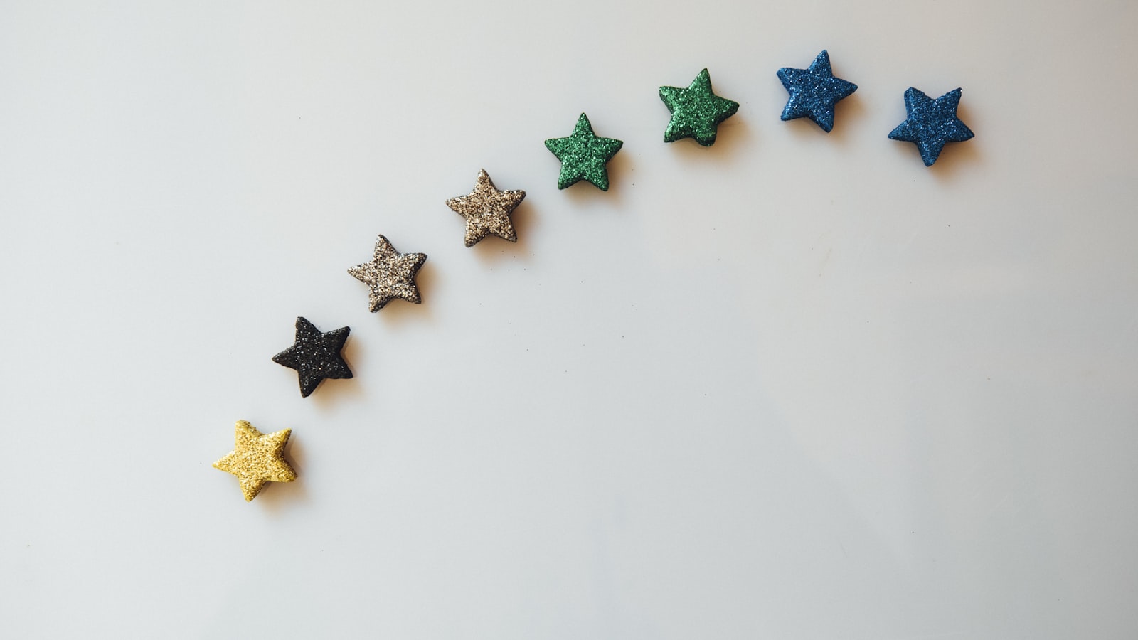 Five glitter stars arranged in a rising curve on a white background, representing an average Google review star rating for a contractor.
