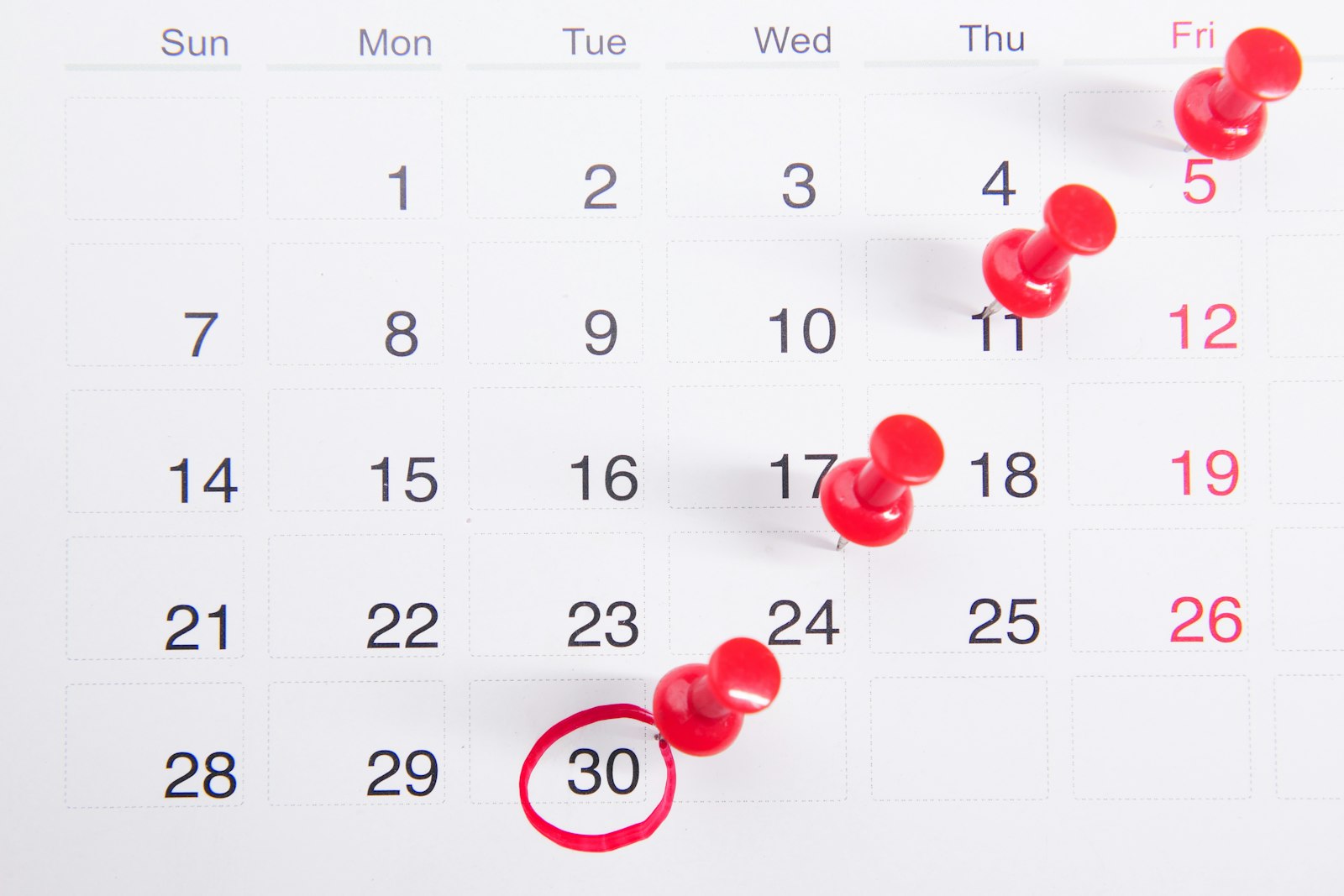 Calendar with pins marking a sequence of follow-up dates