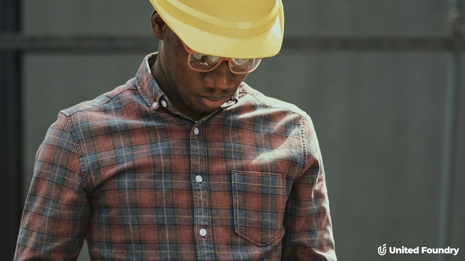 Contractor in a hard hat taking a phone call on a jobsite