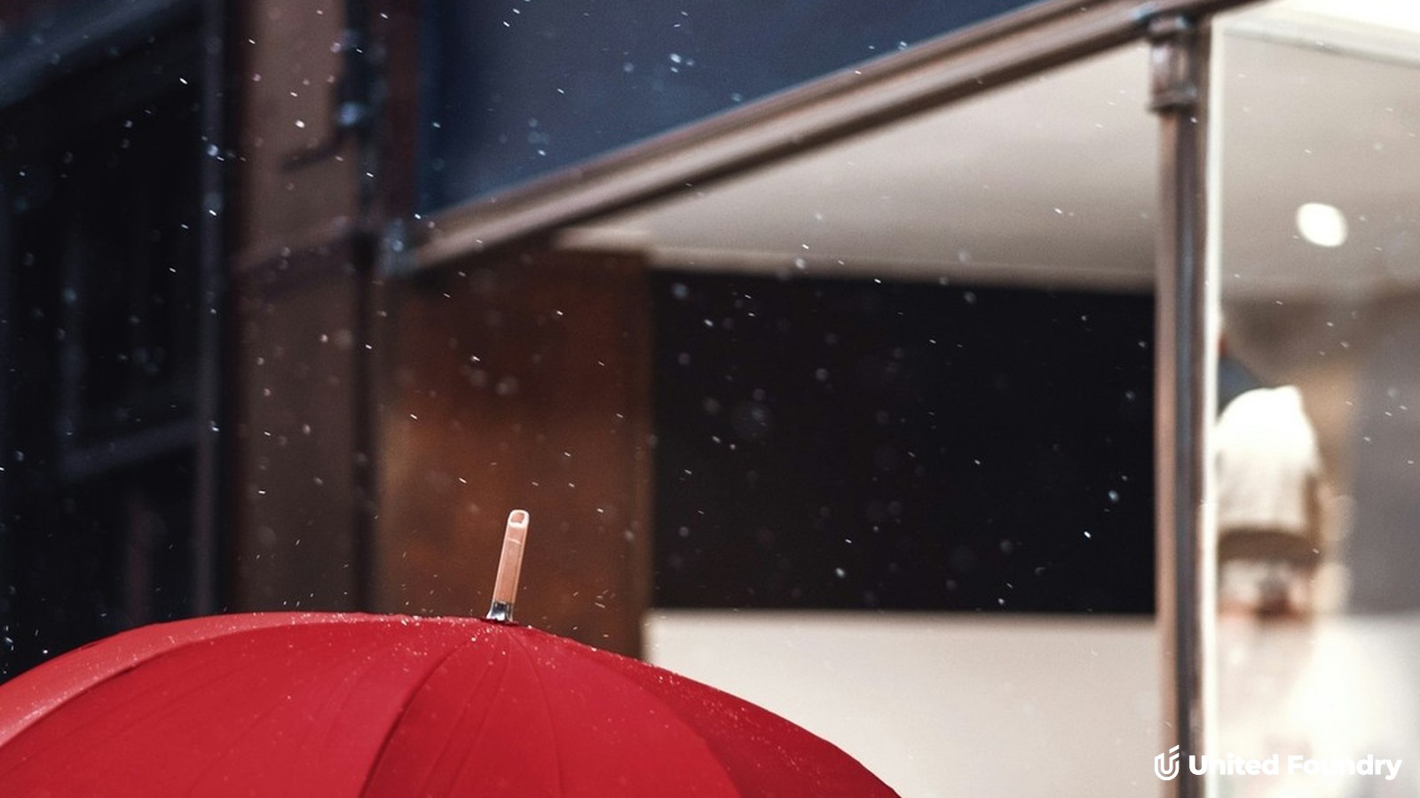 A red umbrella standing out in a gray crowd, symbolizing contractor differentiation