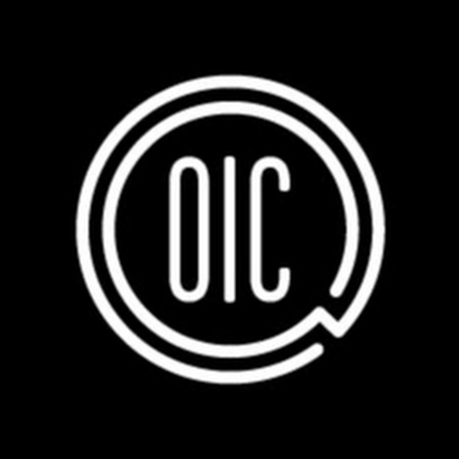 A nonprofit team celebrating after a successful fundraising event, with a video crew capturing candid moments. The setting is a vibrant community center, with banners and happy participants.