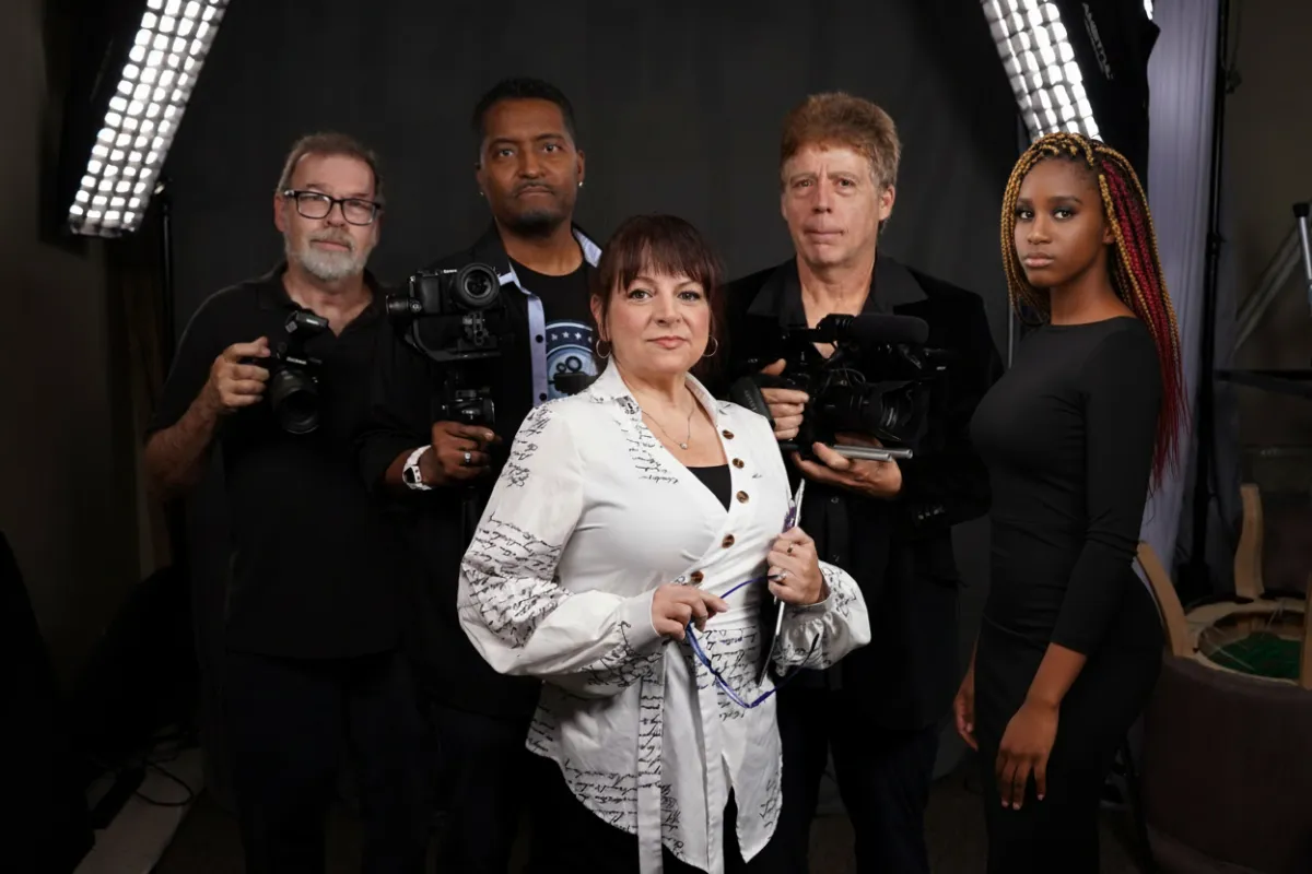 RAM Vision Media team group photo in a modern studio, cinematic lighting, diverse team, confident poses, blue and white tones, cityscape background