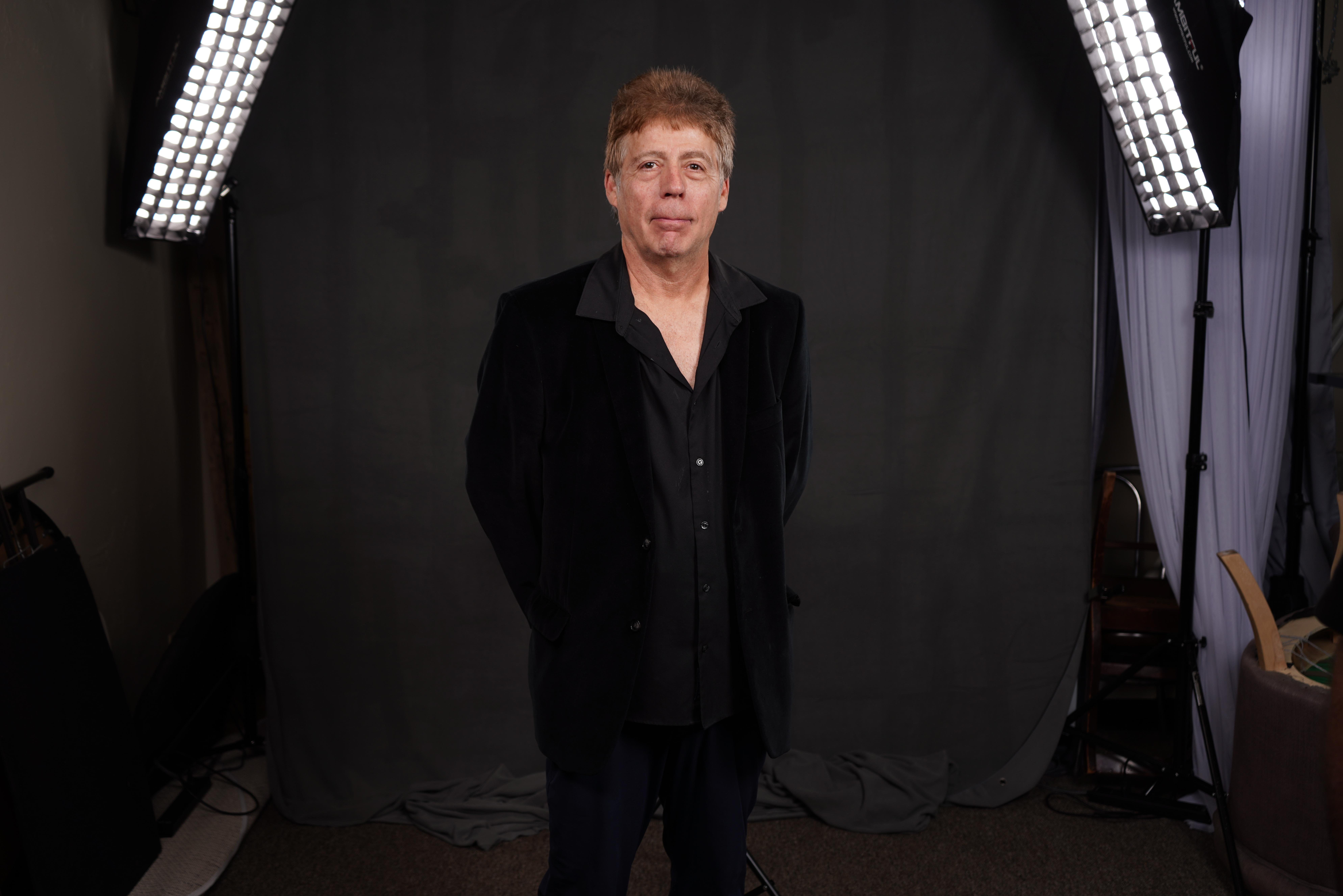 Portrait of Emily Davis, Editor, at editing desk, focused expression, modern workspace, blue accents