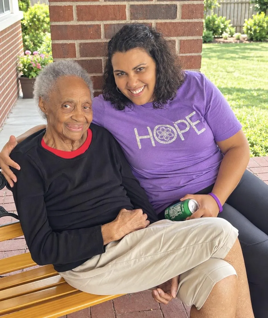 Chasity Robinson Mwangi sharing a warm moment with Vess, reflecting compassionate dementia guidance and family connection.