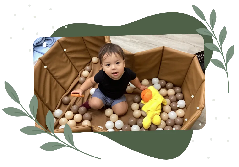 Toddler playing in a ball pit at a childcare center