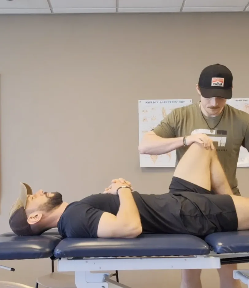 physical therapist assessing a man's knee